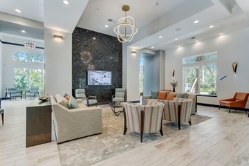 Jacksonville apartment for rent - A modern living room with a large sofa set and a television.