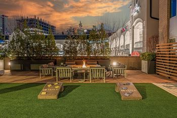 Outdoor lounge with grills, cornhole and firepit