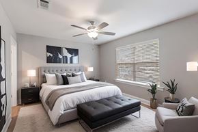 Tallahassee apartment for rent - a bedroom with a bed and a ceiling fan