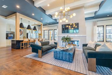 Greenville apartment for rent - A modern living room with a dark blue couch and a wooden coffee table.