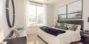 Matthews apartment for rent - A bedroom with a large bed and a large window.