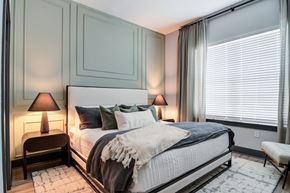 Sugar Hill apartment for rent - A bedroom with a large bed and two lamps.