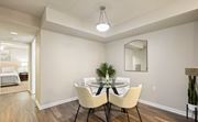 Tallahassee apartment for rent - A dining room with a table set for two and a mirror above it.