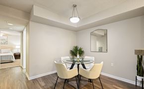Tallahassee apartment for rent - A dining room with a table set for two and a mirror above it.