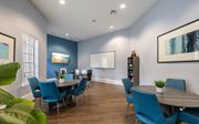 Tallahassee apartment for rent - A dining room with blue chairs and a wooden table.