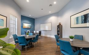 Tallahassee apartment for rent - A dining room with blue chairs and a wooden table.
