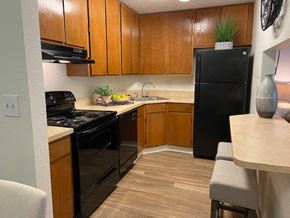 Melbourne apartment for rent - Sleek black appliances add a modern touch to the kitchen at Lake in the Woods, Melbourne