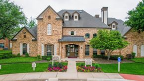 Mansfield townhouse for rent - the front of a brick house with a driveway and landscaping
