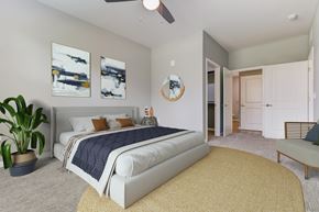 Jacksonville apartment for rent - A bedroom with a large bed and a ceiling fan.