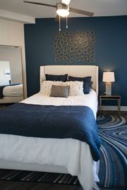 Memphis apartment for rent - a blue and white bedroom with a white bed and a blue accent wall