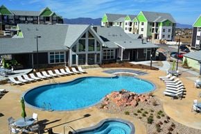 Colorado Springs apartment for rent - an aerial view of a swimming pool in front of an apartment building