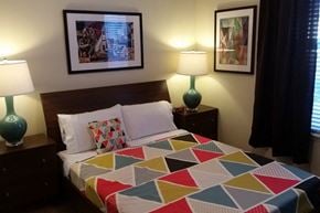 Colorado Springs apartment for rent - a bedroom with a bed with a colorful quilt