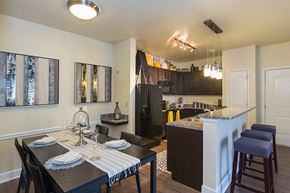 Colorado Springs apartment for rent - an open kitchen and dining room with a table and chairs