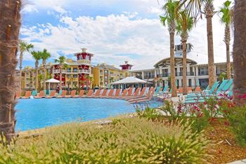Resort pool with sand beach entry and swim up bar