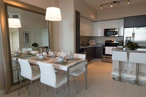 Fort Lauderdale apartment for rent - a dining room with a table and chairs and a kitchen in the background