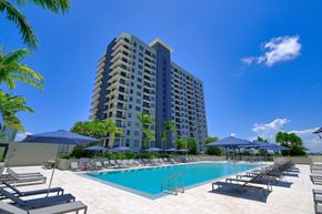 Fort Lauderdale apartment for rent - a large swimming pool with chaise lounge chairs and umbrellas in front of a tall at Regatta at New River, Florida, 33301