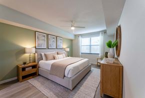 Wellington apartment for rent - A bedroom with a large bed and a wooden nightstand.
