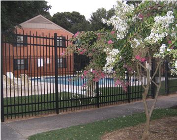 Atlanta apartment for rent - a wrought iron fence with a swimming pool in front of a house