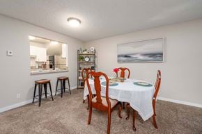 Bellevue apartment for rent - A dining room with a table set for two and a painting on the wall.