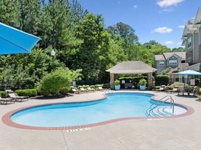 Cleveland apartment for rent - A swimming pool surrounded by trees and a gazebo.