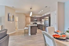 Easley apartment for rent - A modern kitchen with a dining table set for two.