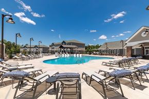 Easley apartment for rent - A pool surrounded by sun loungers and umbrellas.