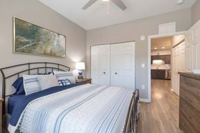 Easley apartment for rent - A bedroom with a large bed and a painting on the wall.