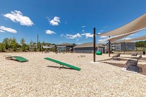 Easley apartment for rent - A playground with a green bench and a shade structure.