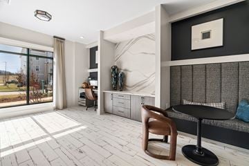 Johnson City apartment for rent - A modern living room with a wooden chair and a black table.