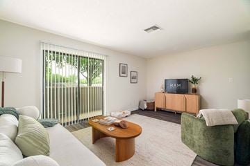 Knoxville townhouse for rent - A living room with a sofa, a coffee table, and a television.