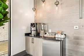 Johnson City apartment for rent - A modern kitchen with a stainless steel refrigerator and wooden cabinets.