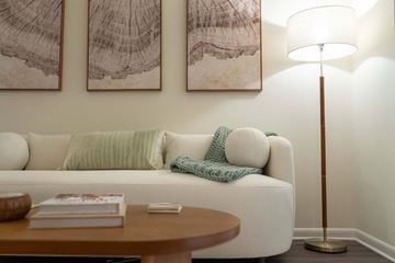 Knoxville townhouse for rent - A living room with a white couch, a wooden coffee table, and two abstract paintings on the wall.