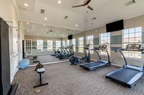 Prosper apartment for rent - a gym with exercise equipment and windows in a building at Orion Prosper, Prosper, TX, 75078