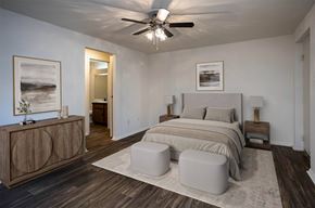 Knoxville apartment for rent - A bedroom with a bed, nightstands, and a ceiling fan.