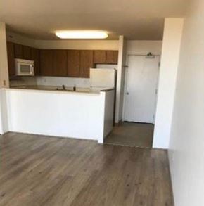 Aiea apartment for rent - A kitchen with wooden cabinets and a white counter.