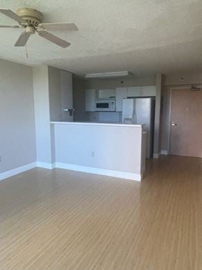 Honolulu condo for rent - an empty living room with a ceiling fan