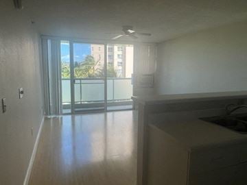 Honolulu condo for rent - A kitchen with a window and a fan.