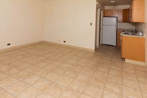 Haleiwa apartment for rent - an empty room with a kitchen and a refrigerator