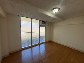 Honolulu apartment for rent - A room with a sliding glass door leading to a balcony.