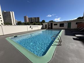 Honolulu condo for rent - A small pool with a green border and a metal ladder.