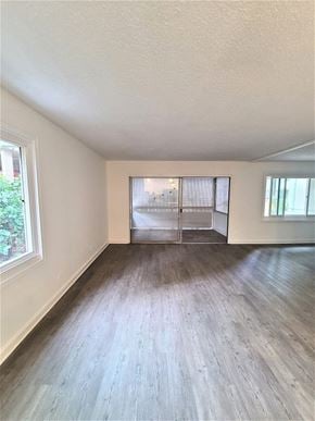 Honolulu condo for rent - A room with wooden flooring and a window.