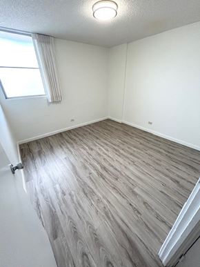 Honolulu apartment for rent - A room with a window and wooden flooring.
