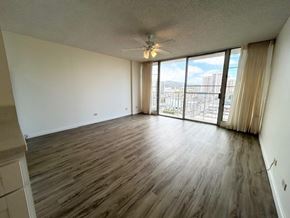 Honolulu apartment for rent - A room with wooden flooring and a ceiling fan.
