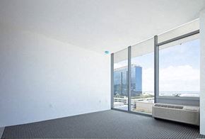 Honolulu condo for rent - a living room with a large window and a radiator