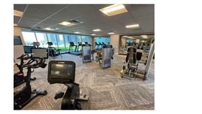 Honolulu condo for rent - a room filled with lots of different types of exercise equipment