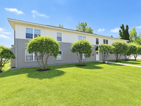 South Burlington apartment for rent - A house with a grey and white exterior and a green lawn.