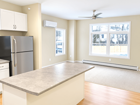 South Burlington apartment for rent - A kitchen with a refrigerator, a counter, and a window.
