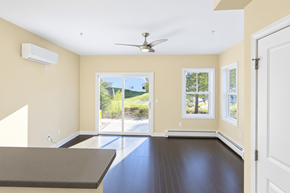 South Burlington apartment for rent - A room with a ceiling fan and sliding glass doors.
