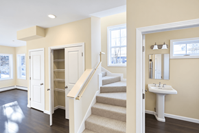 South Burlington apartment for rent - A white sink is in a white cabinet in a room with a staircase.