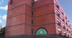 Burlington apartment for rent - Exterior of multi-story brick McKenzie House apartment building